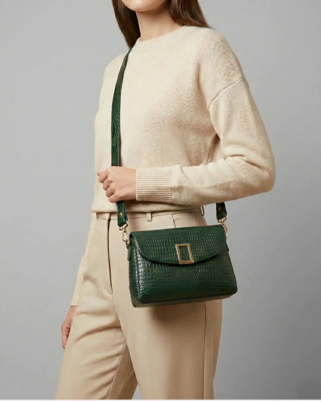 Woman Carrying croco textured green sling bag