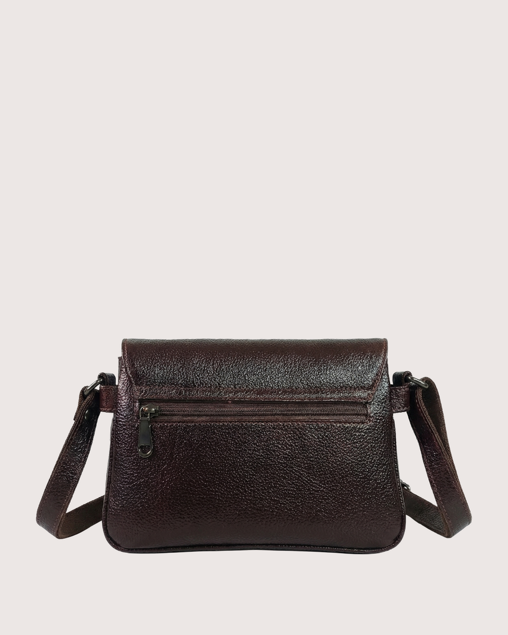 Brown leather crossbody bag on a light beige background