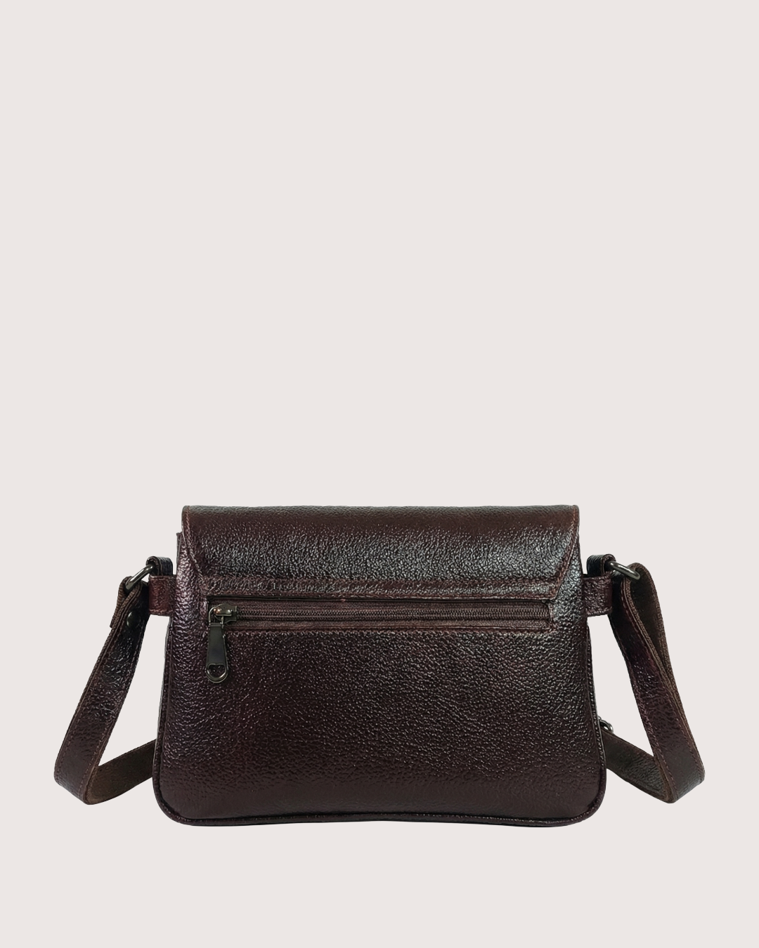 Brown leather crossbody bag on a light beige background