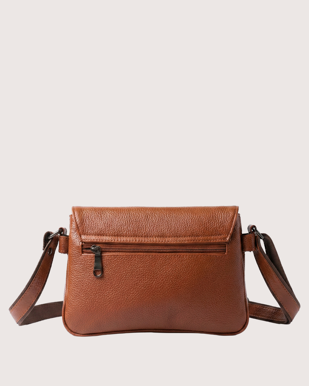 Brown leather crossbody bag on a light beige background