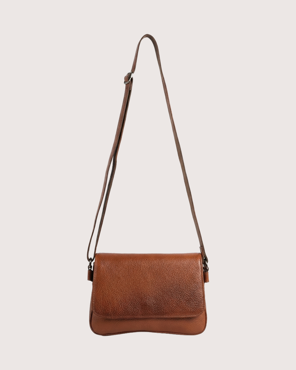 Tan leather crossbody bag on a light beige background
