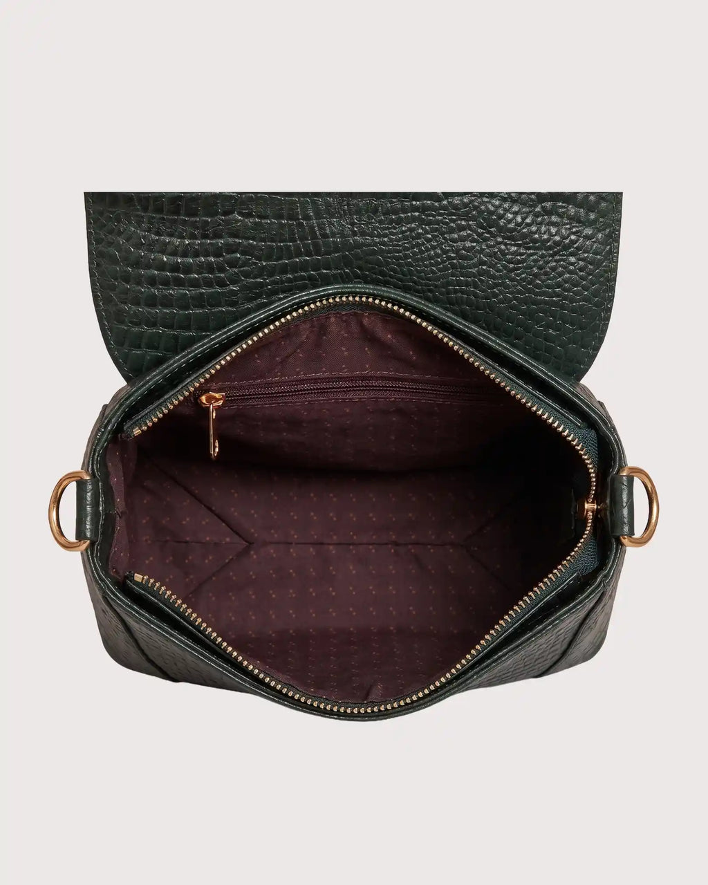 Interior of green croc-embossed purse featuring spacious compartment and secure storage pockets