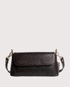 Brown croc-embossed shoulder bag with flap closure, structured silhouette, and gold-tone hardware