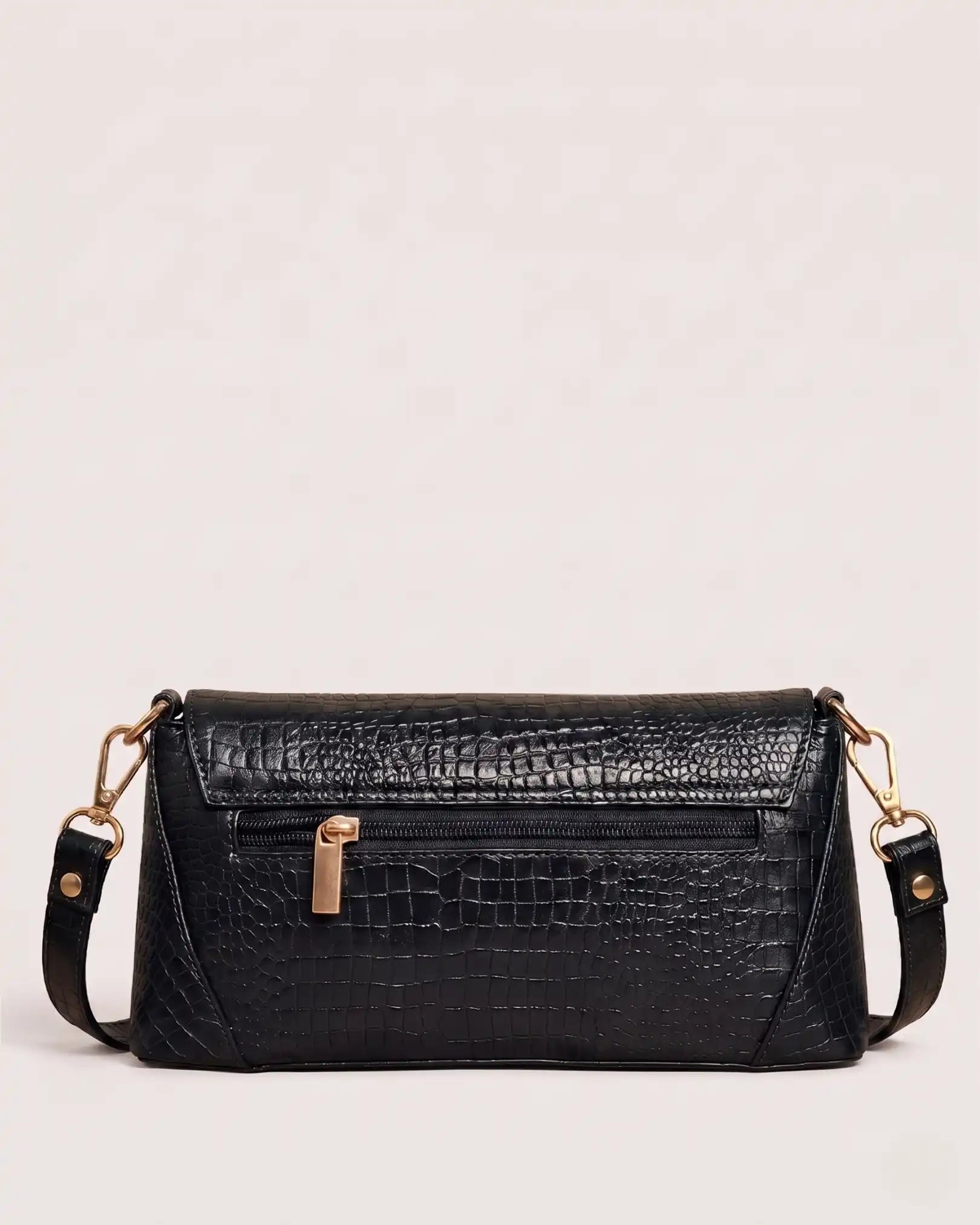 Back view of black croc-embossed handbag with zippered pocket and adjustable shoulder strap