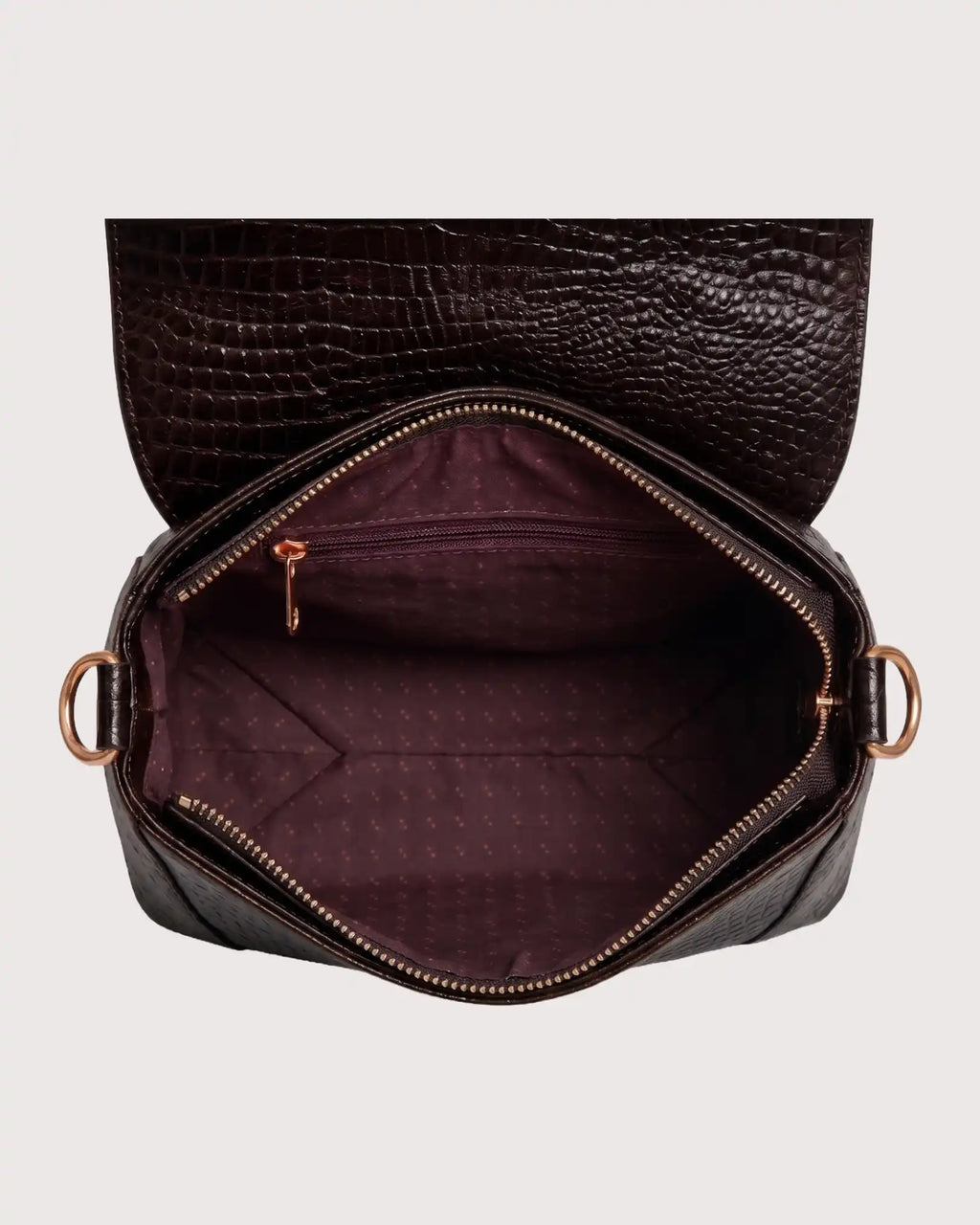 Interior of brown croc-embossed purse featuring spacious compartment and secure storage pockets