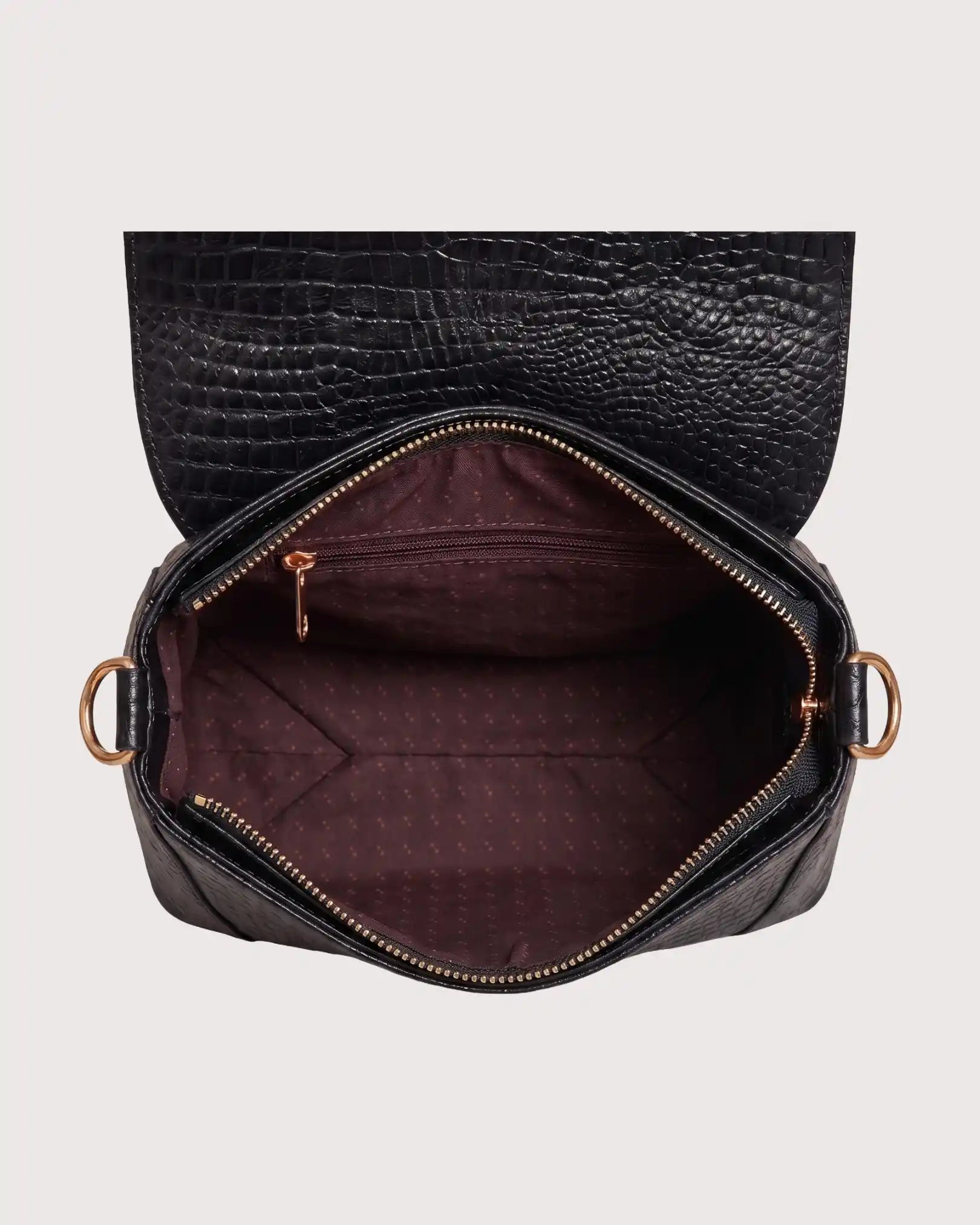 Interior of black croc-embossed purse featuring spacious compartment and secure storage pockets